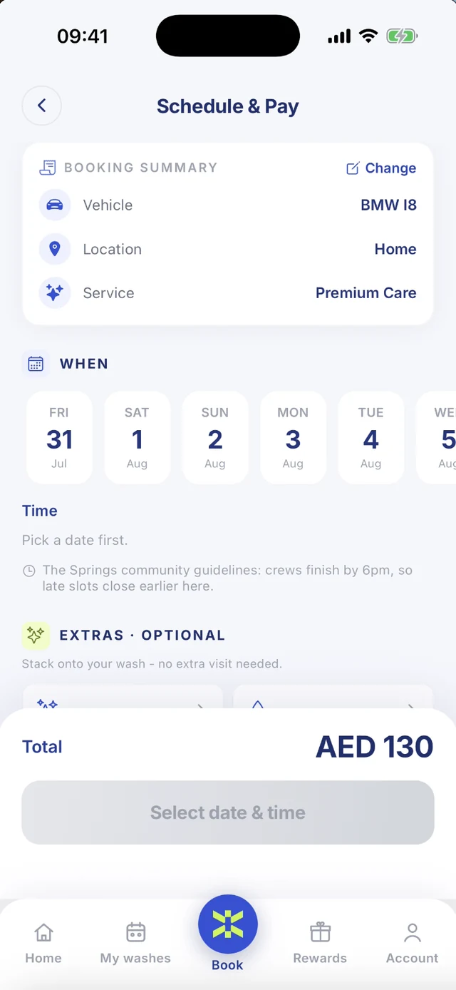 The Schedule & Pay screen: a summary of a Premium Care wash on the BMW i8 at home, a row of dates to pick from starting Friday 31 July, and a note that this community's crews finish by 6pm so late slots close earlier, with the AED 130 total pinned to the bottom.
